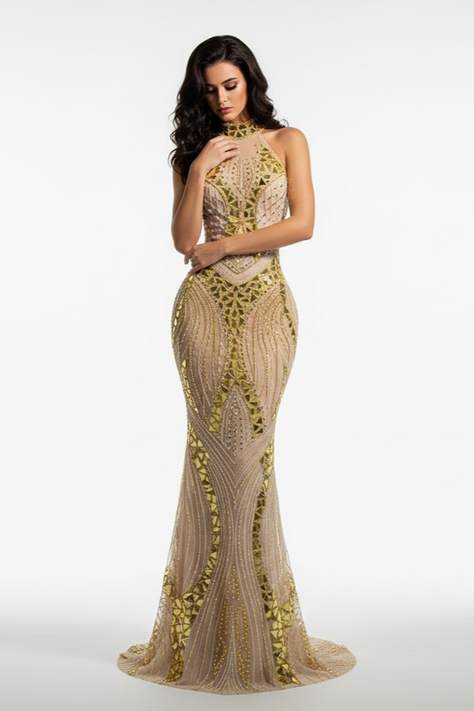 Woman wearing a gold and beige evening gown on a white background