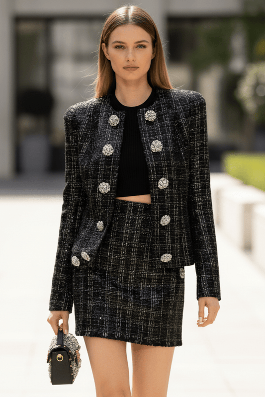 Astrid Noir Rhinestone Tweed Blazer & Mini Skirt Set by Shine | one set from Luxe Lane | SKU: -1 | Barcode: | Options: Black S | Woman in a black and silver tweed suit with a blurred outdoor background