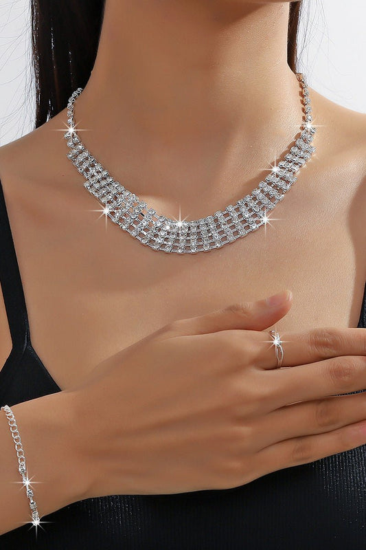 Rhinestone Chain Jewelry Set – Necklace, Bracelet & Earrings by CJ | 0 from Luxe Lane | SKU: CJLX232427001AZ | Barcode: | Options: | Silver necklace, ring, and bracelet on a person against a neutral background