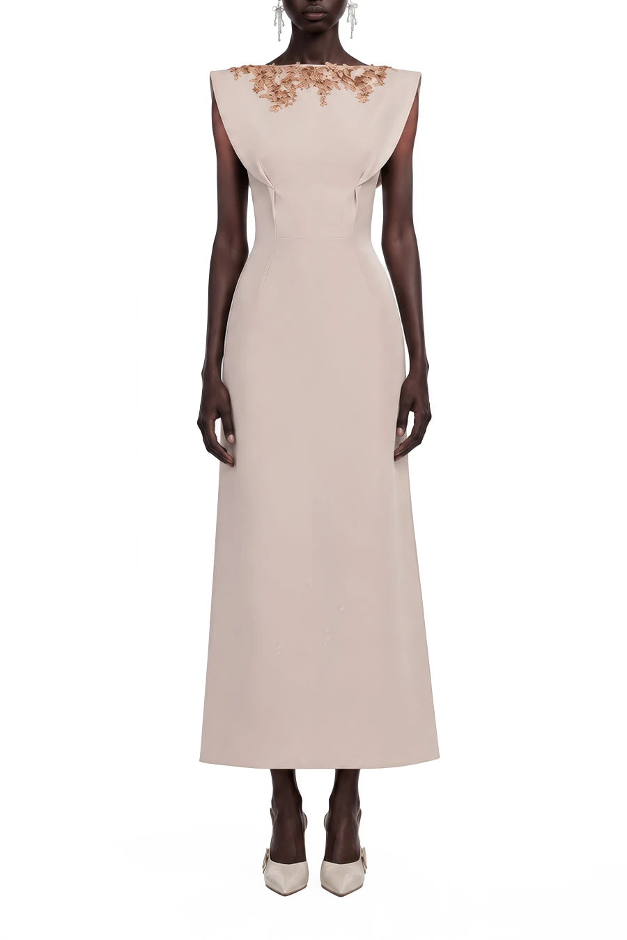 A sleeveless floor-length gown in a pale blush pink, featuring a structured high neckline adorned with metallic gold floral embroidery, modeled on a dark-skinned mannequin against a plain white background.
