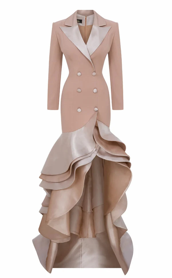 A beige and champagne-colored high-low gown featuring a structured blazer-style bodice with double-breasted buttons, a notched lapel, and dramatic layered ruffles cascading down the skirt.