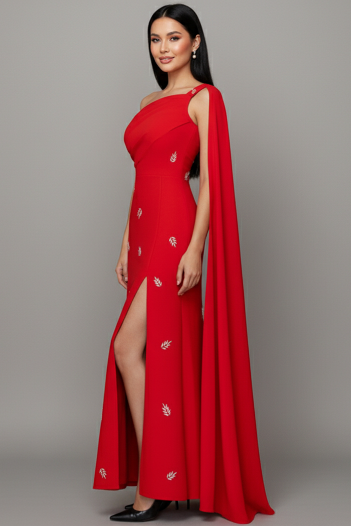 Woman wearing a red evening gown with a cape on a gray background
