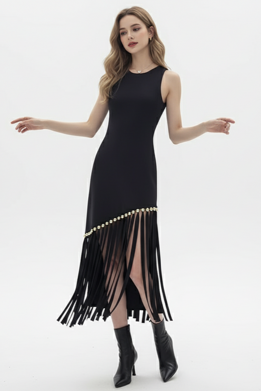 Black dress with fringe details worn by a model on a white background