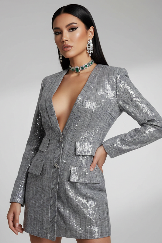 Woman wearing a gray sequin dress against a gray background