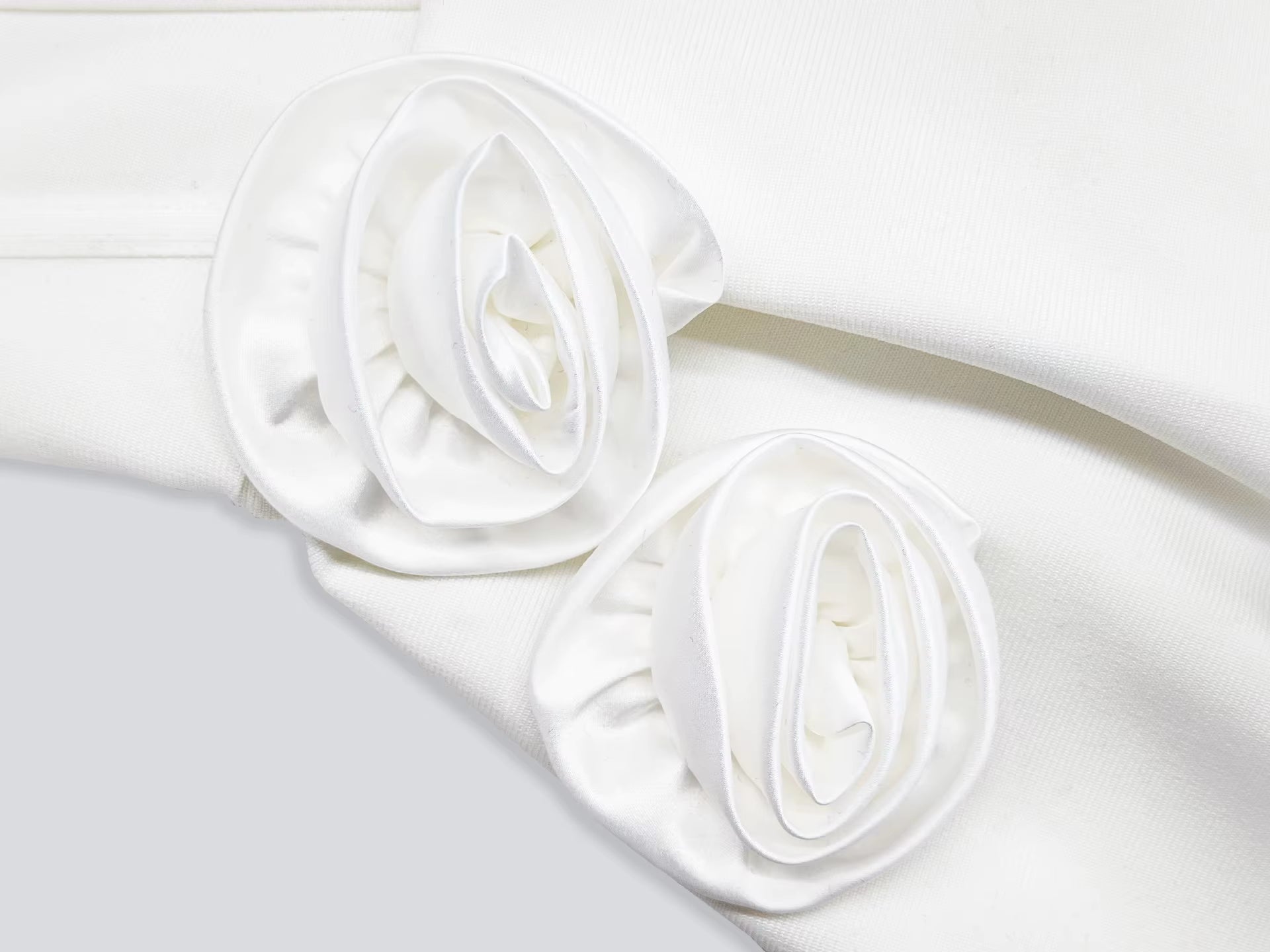 Rolled-up white fabric on a light gray background