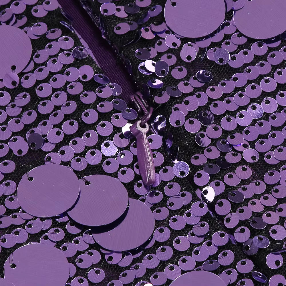 Close-up of purple sequins on a black background