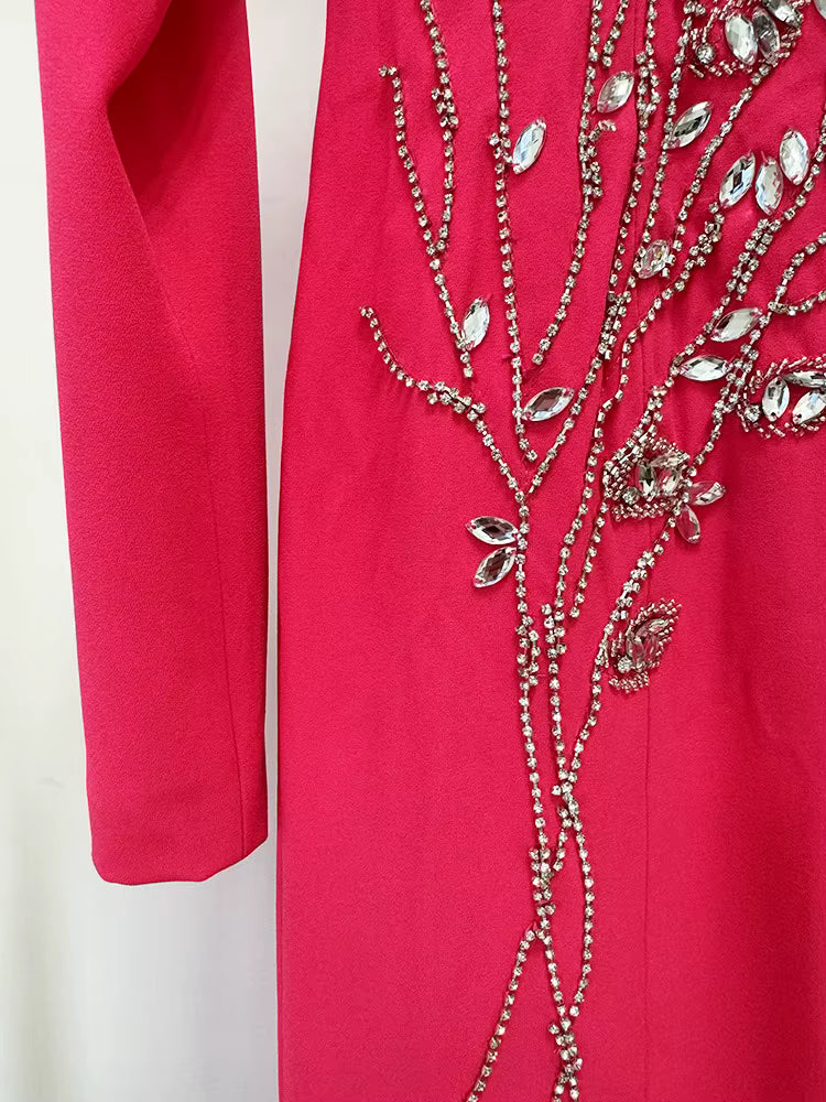 Red garment with silver bead embellishments on a white background