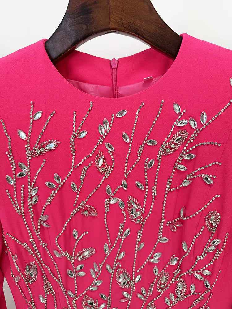 Pink dress with silver bead embellishments on a hanger
