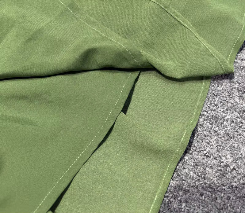 close-up of Luxe Lane off-shoulder neckline showing fine ruching and smooth olive green fabric texture