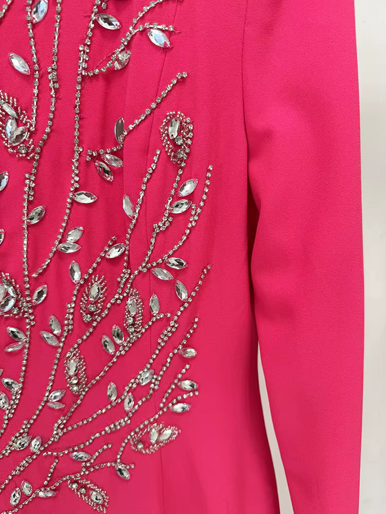 Pink garment with silver floral embroidery on a white background
