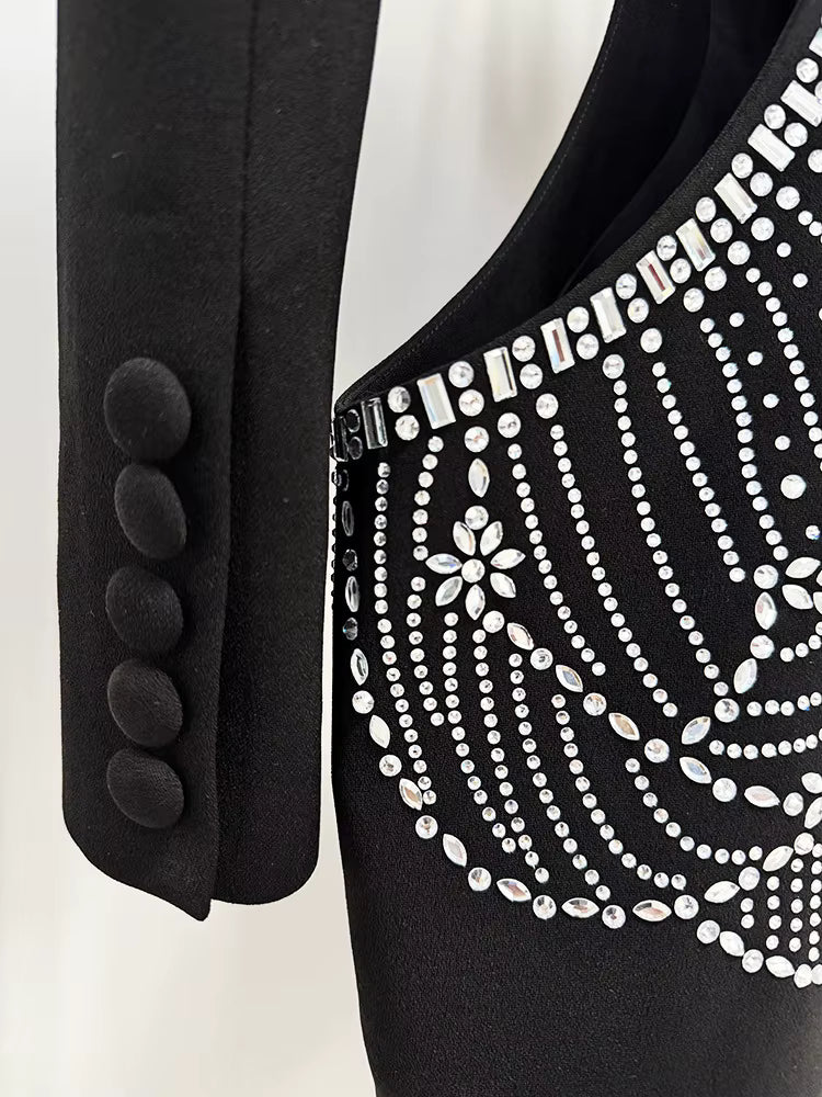 Black blazer with decorative buttons and a black dress with white embellishments on a white background