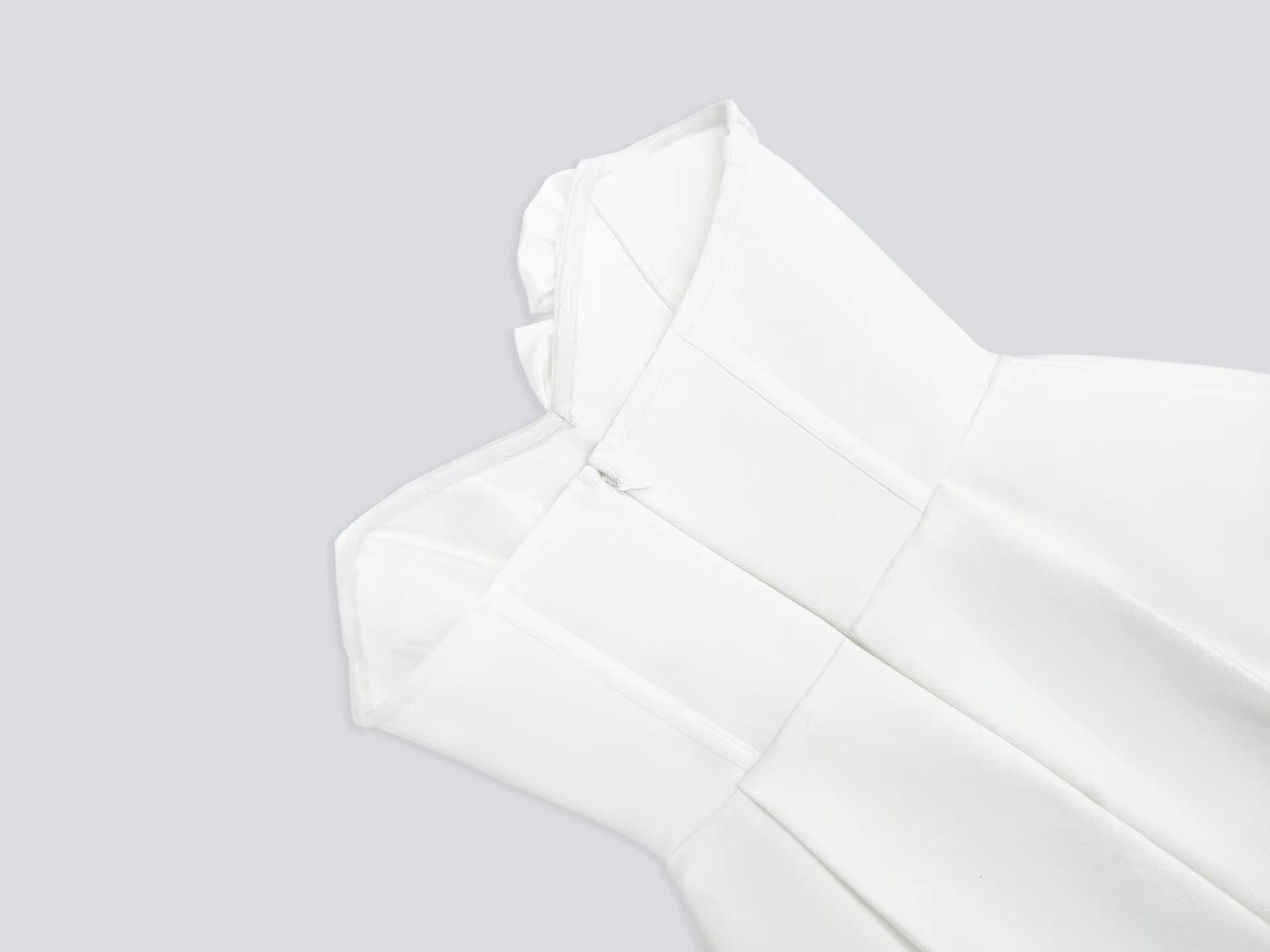 White sleeveless top on a light gray background