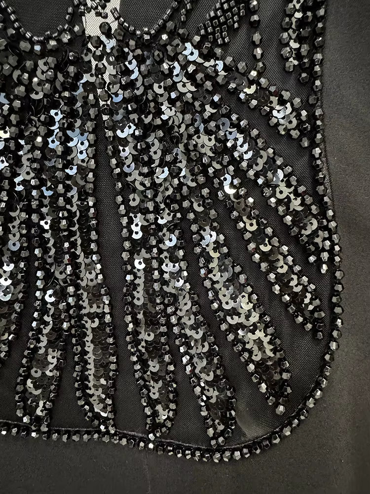 Close-up of a black dress with silver sequin detailing