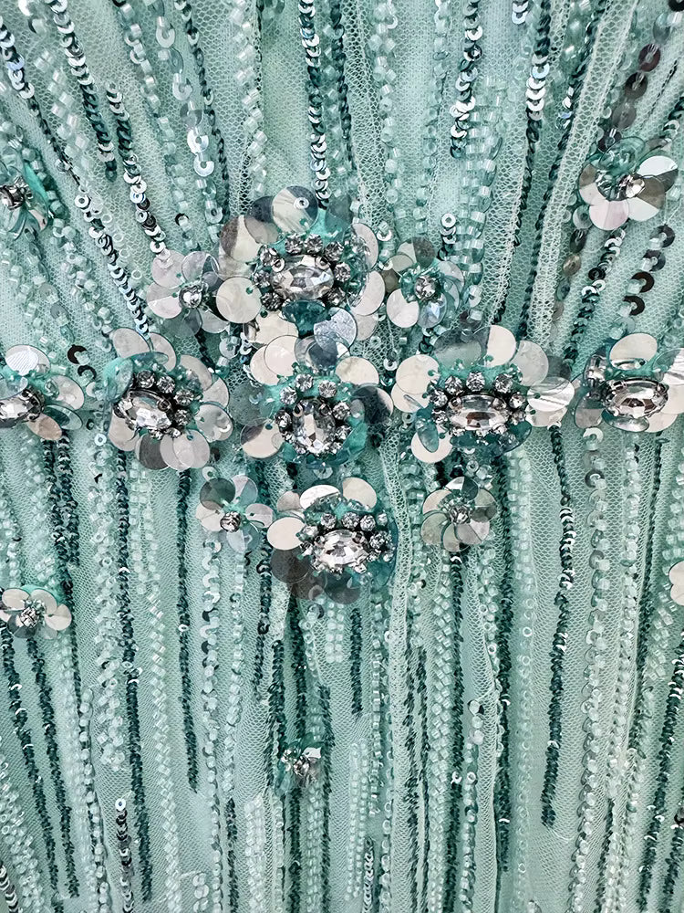 macro shot of Luxe Lane aqua gown beadwork featuring gemstone accents and vertical sequin lines