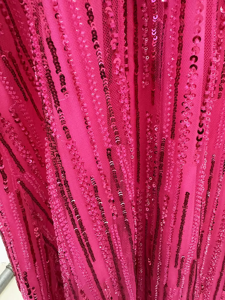 close-up of Luxe Lane fuchsia sequin fabric showing vertical beadwork and intricate hand stitching
