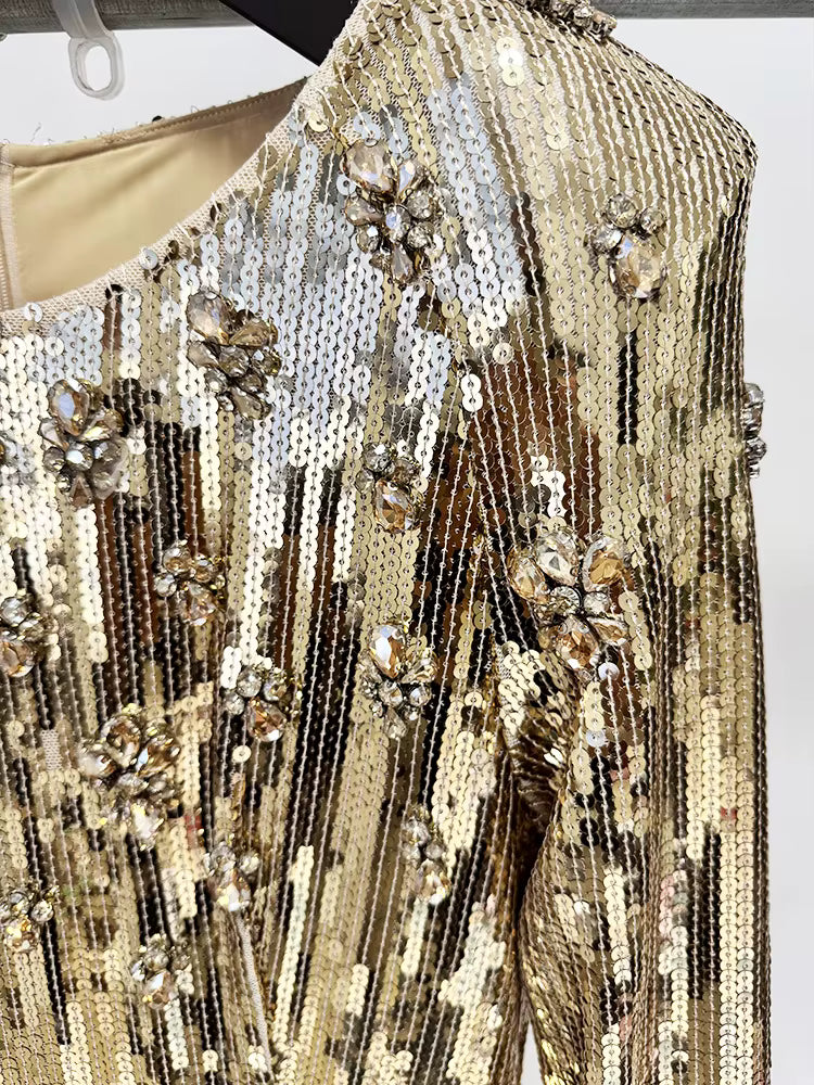 detailed shot of Luxe Lane gold waist embellishment and sparkling sequin texture on gown

