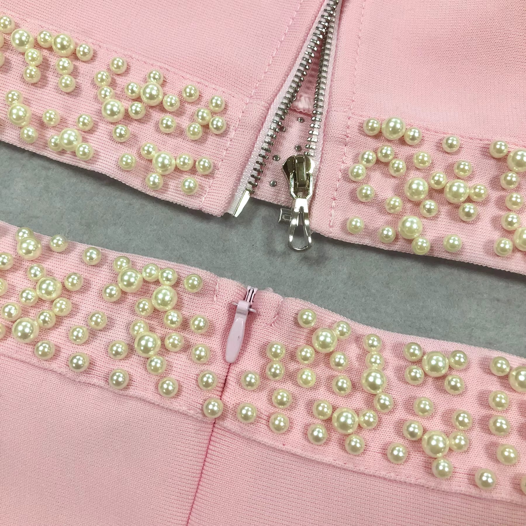 macro shot of Luxe Lane pearl-lined edge on pink two-piece bandage skirt set
