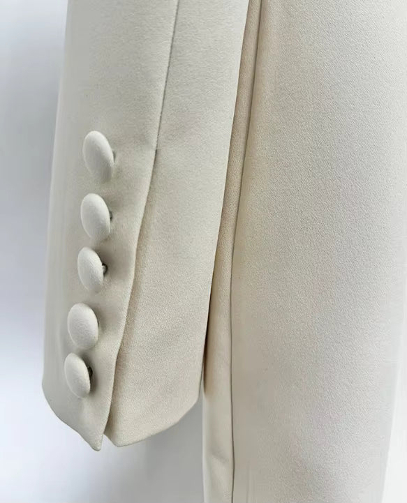 macro shot of Luxe Lane white blazer embroidery showing golden bead and sequin embellishments