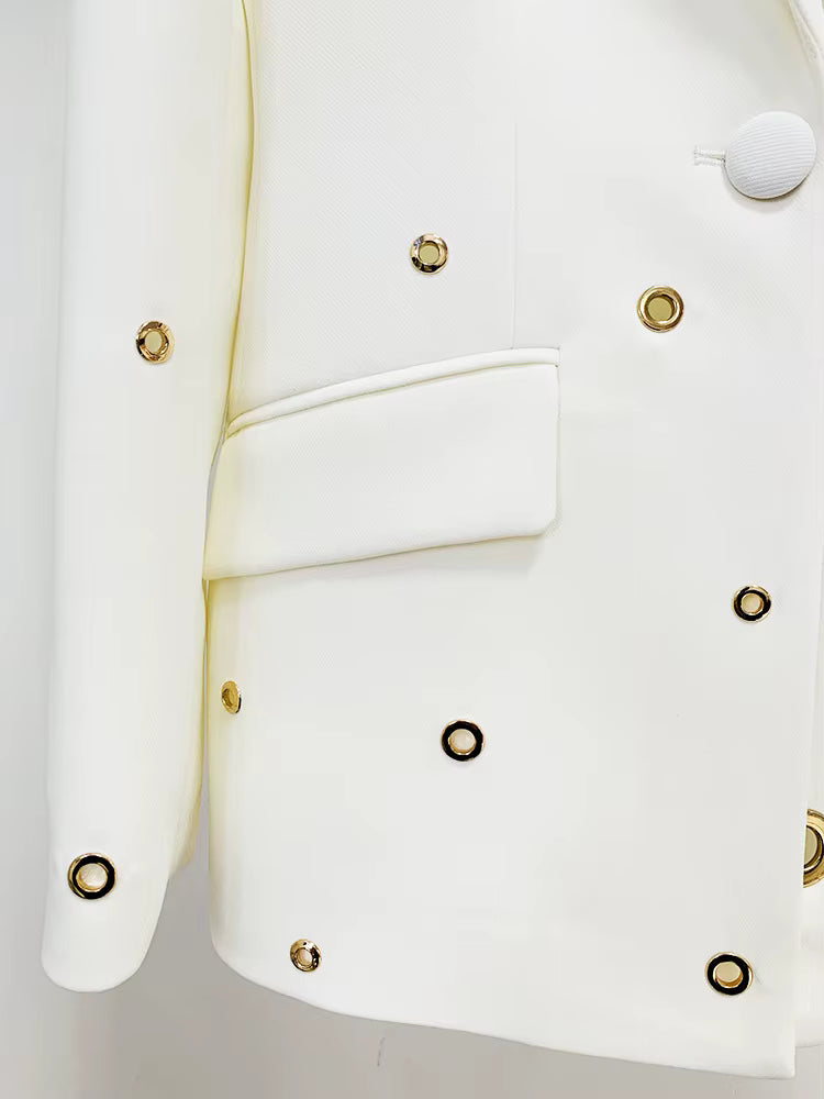 close-up of Luxe Lane white trousers hem with gold button detailing and fine tailoring