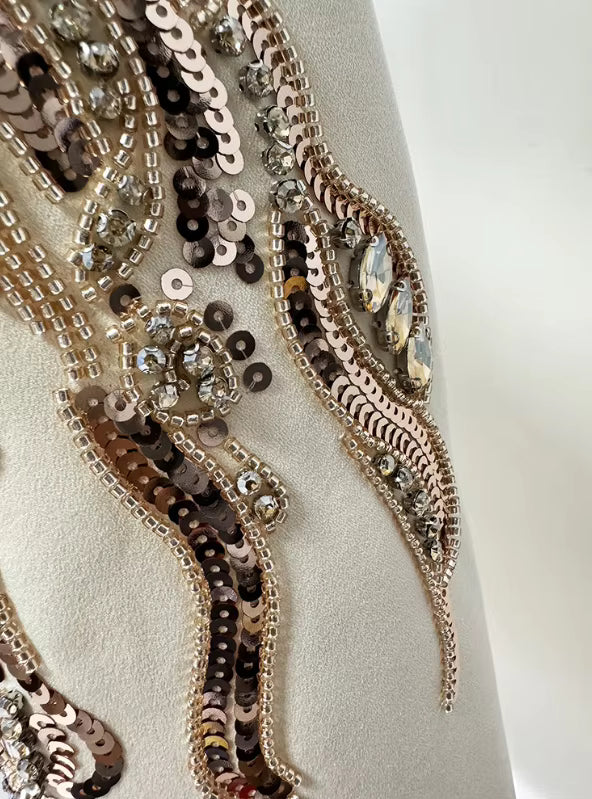 detailed shot of Luxe Lane white blazer sleeve buttons and delicate fabric texture