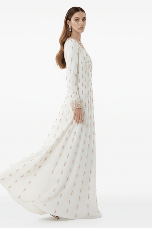 Amarise Beaded Sequin Evening Gown by Shine | heath gown from Luxe Lane | SKU: W11558-1 | Barcode:  | Options: White S | Woman wearing a long white dress with gold patterns on a white background