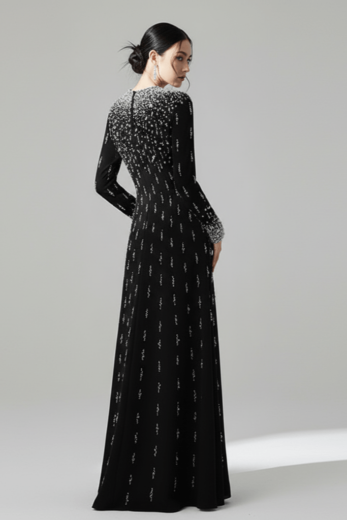 Amarise Beaded Sequin Evening Gown by Shine | heath gown from Luxe Lane | SKU: W11558-1 | Barcode:  | Options: White S | Woman wearing a black evening gown with silver embellishments on a gray background