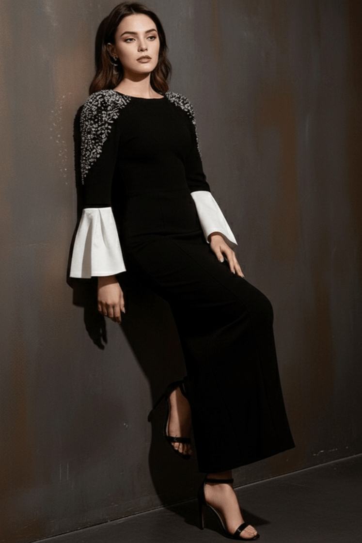 Amarise Rhinestone Puff - Sleeve Gown by Shine | heath gown from Luxe Lane | SKU: -1 | Barcode:  | Options: Black S | Woman wearing a black outfit with white cuffs and shoulder details against a dark background