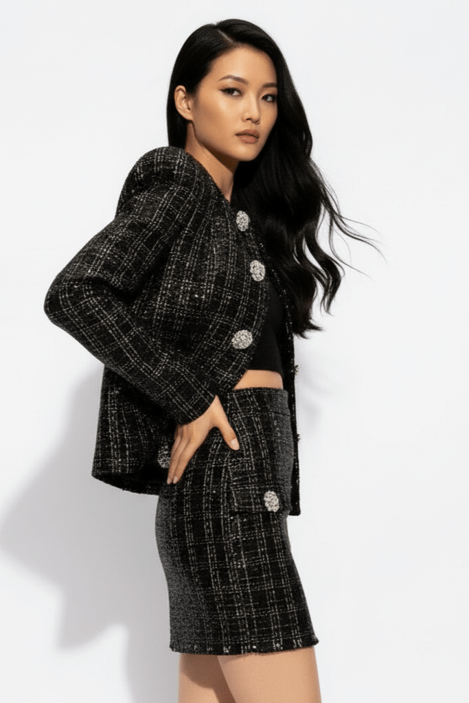 Astrid Noir Rhinestone Tweed Blazer & Mini Skirt Set by Shine | one set from Luxe Lane | SKU: -1 | Barcode:  | Options: Black S | Woman wearing a black and white checkered outfit with silver buttons on a white background