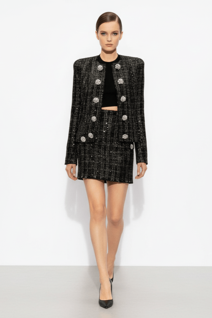 Astrid Noir Rhinestone Tweed Blazer & Mini Skirt Set by Shine | one set from Luxe Lane | SKU: -1 | Barcode:  | Options: Black S | Model wearing a black and silver blazer with a matching skirt on a white background