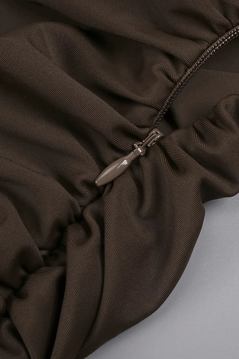 Aurelia Coffee Halter Cutout Pleated Maxi Dress by Luxe Lane | from Luxe Lane | SKU: -1 | Barcode:  | Options: Coffee XS(4) | Close - up of a brown fabric with a zipper on a light gray background