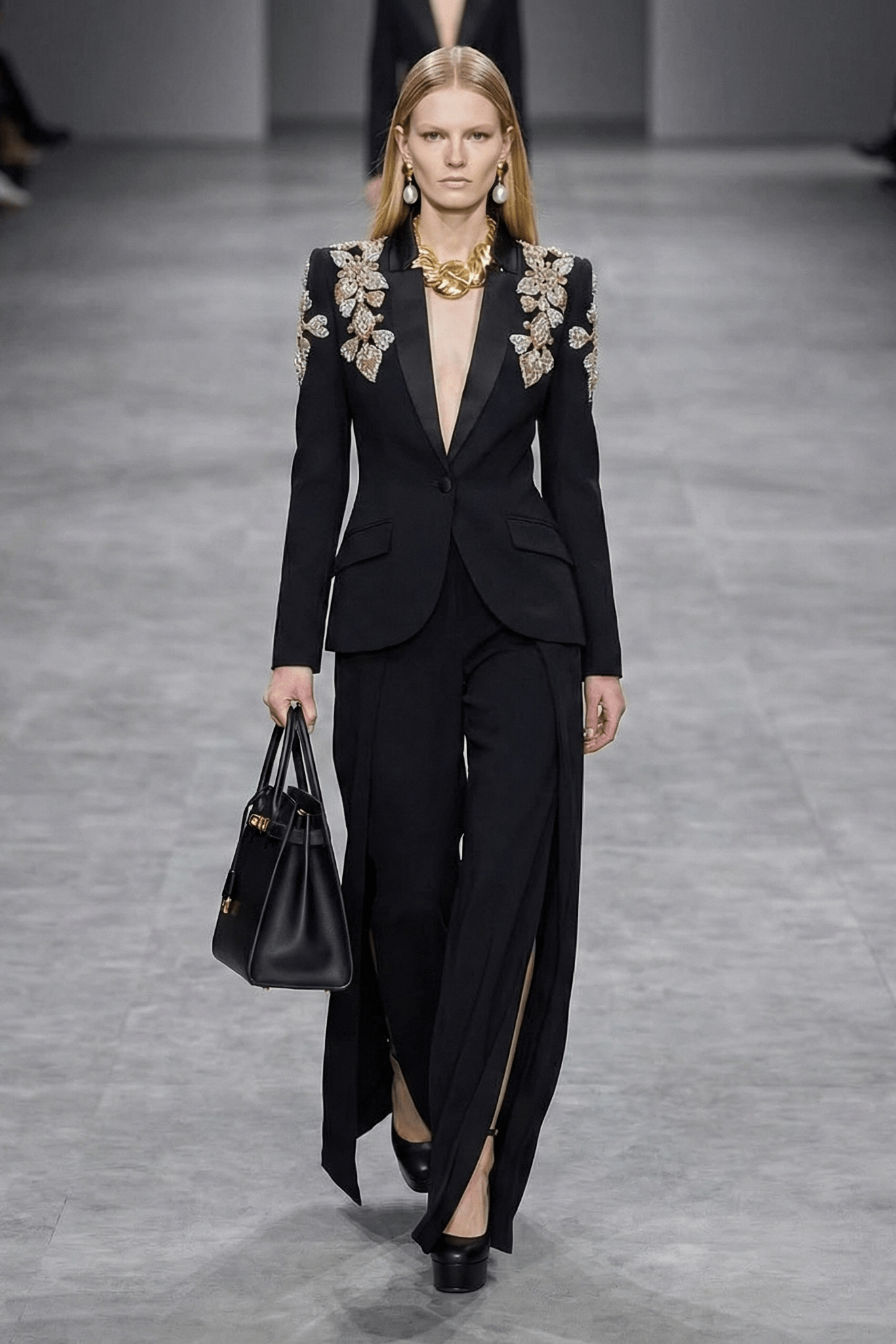 Beaded Blazer & Slit Wide - Leg Pant Set by Luxe Lane | Pants Suits from Luxe Lane | SKU: 1688358-1 | Barcode:  | Options: Black S(6) | Model walking on a runway wearing a black outfit with floral embellishments.