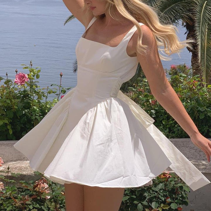 Blanche Bow - Front Backless Flare Dress by Luxe Lane | from Luxe Lane | SKU:  | Barcode:  | Options: White XS | Custom Woman Summer Dresses 2025 Women's Clothing Elegant Vestidos Casuales Bow Backless Sexy White Short Flare Dress for Women
