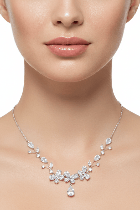 Butterfly Zircon Bridal Necklace & Earrings Set by CJ | 0 from Luxe Lane | SKU: CJYD247022401AZ | Barcode:  | Options: White | Silver necklace with floral design on a model against a white background