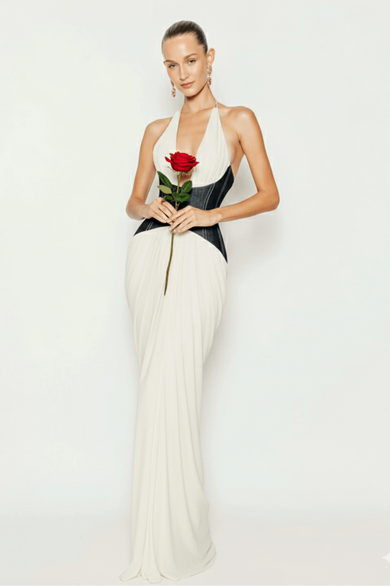 Capri Halter Corset Dress by Shine | Dresses from Luxe Lane | SKU:  | Barcode:  | Options: White XS | Woman in a white and black dress holding a red rose against a white background