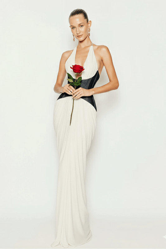 Capri Halter Corset Dress by Shine | Dresses from Luxe Lane | SKU:  | Barcode:  | Options: White XS | Woman in a white and black dress holding a red rose against a white background