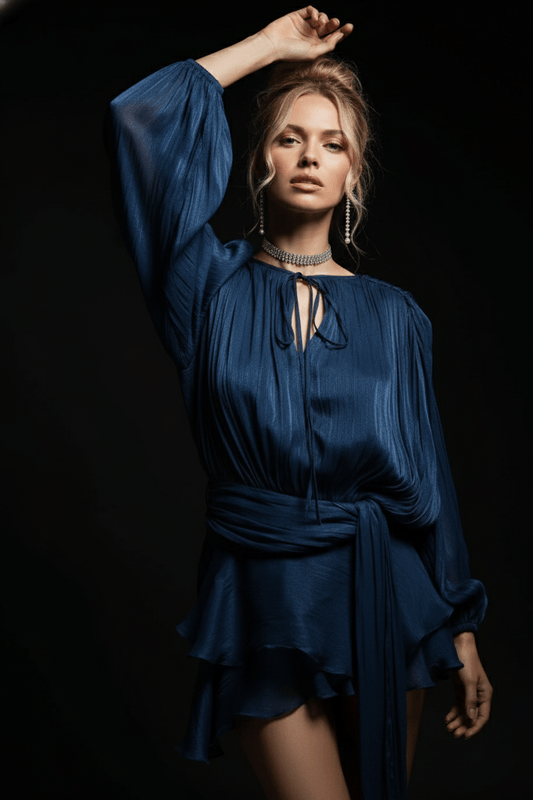 Celesta Pleated Ribbon Mini Dress by Luxe Lane | from Luxe Lane | SKU: -17 | Barcode:  | Options: navy blue S | Woman wearing a blue dress against a black background