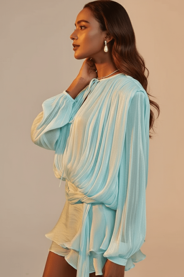 Celesta Pleated Ribbon Mini Dress by Luxe Lane | from Luxe Lane | SKU: -49 | Barcode:  | Options: purple S | Woman wearing a light blue and yellow outfit against a beige background