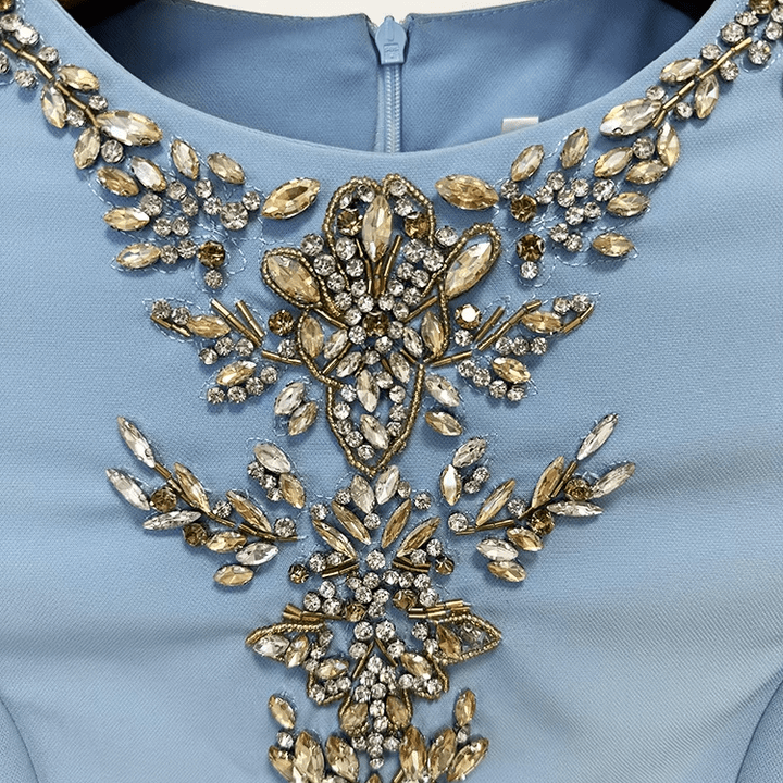 Celeste Regalia Crystal Gown by Luxe Lane | Evening Dresses from Luxe Lane | SKU: W11318-1 | Barcode:  | Options: Sky Blue S | Elegant Light Blue Maxi Occassion Dress Luxurious Beaded Gold Rhinestones Neckline Long Sleeve Formal Party Gown Evening Dresses