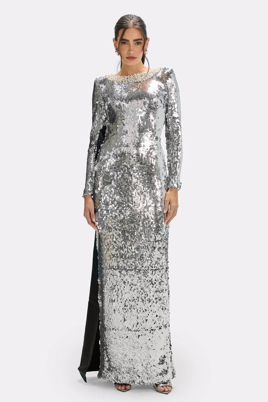 Celestine Handmade Silver Sequin Bow Maxi Gown by Luxe Lane | from Luxe Lane | SKU: -1 | Barcode:  | Options: Silver S(2) | Woman wearing a silver sequin gown on a white background