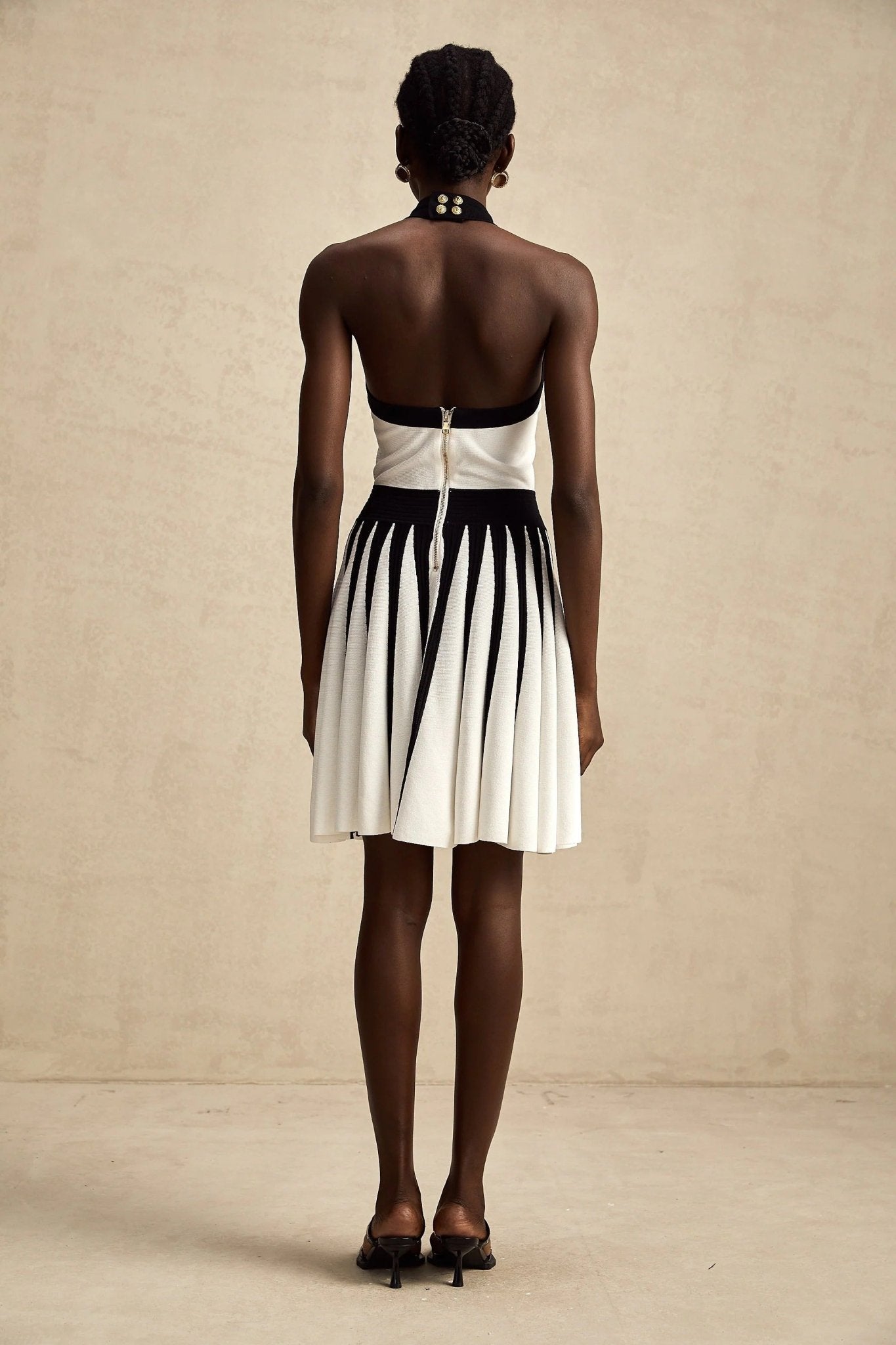 Contrast Halter Neck Pleated Mini Dress by Luxe Lane | from Luxe Lane | SKU: -1 | Barcode:  | Options: Black S(6) | Woman wearing a black and white dress with a plain background