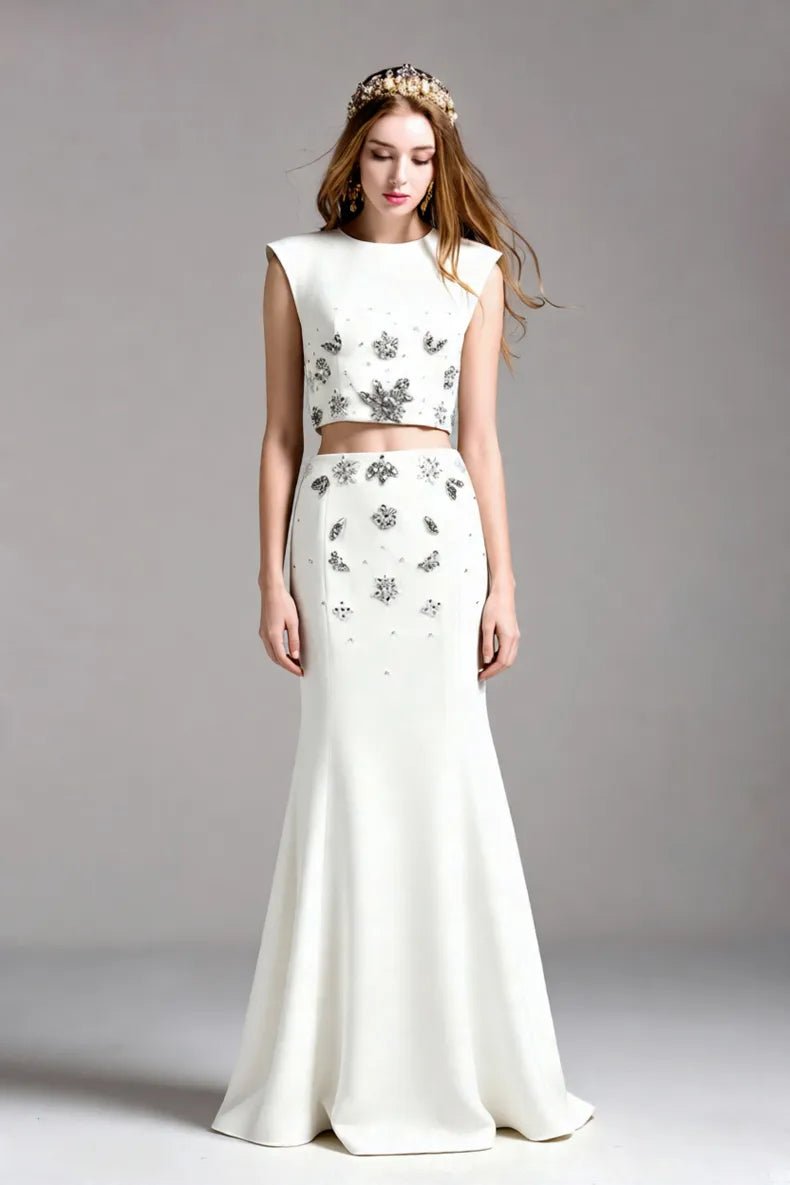 Crystal Floral Two - Piece Maxi Skirt Set by Luxe Lane | one set from Luxe Lane | SKU: -1 | Barcode:  | Options: White S(2) | Woman wearing a white two - piece outfit with floral embellishments on a gray background