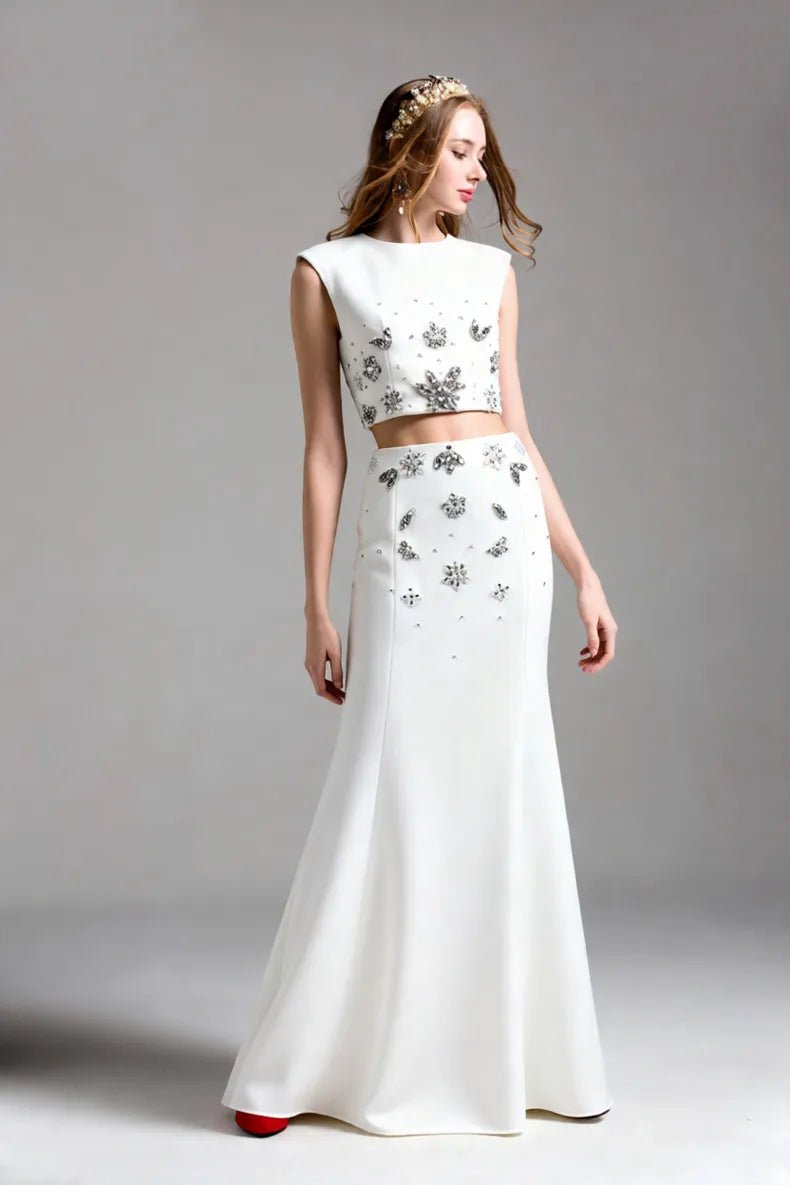 Crystal Floral Two - Piece Maxi Skirt Set by Luxe Lane | one set from Luxe Lane | SKU: -1 | Barcode:  | Options: White S(2) | Woman wearing a white two - piece outfit with floral patterns on a gray background