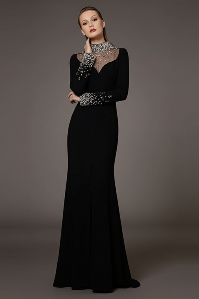 Custom Design Black Crystal - Beaded Evening Gown by Luxe Lane | a - line gown from Luxe Lane | SKU:  | Barcode:  | Options: Black S(6) | Woman wearing a black evening gown with silver embellishments on a gray background