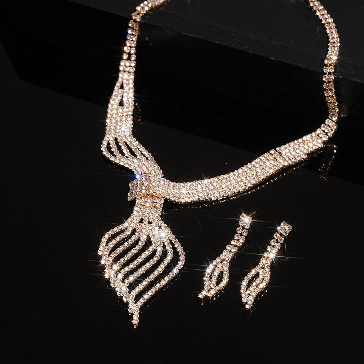 Diamond Clavicle Chain Necklace & Earrings Set by CJ | 0 from Luxe Lane | SKU: CJLX246770501AZ | Barcode:  | Options: Gold | Diamante necklace and earrings set on a black background