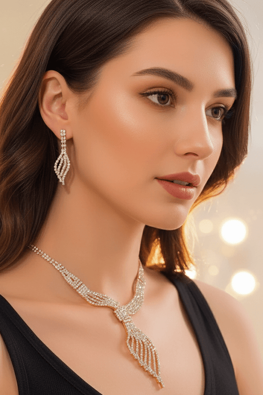Diamond Clavicle Chain Necklace & Earrings Set by CJ | 0 from Luxe Lane | SKU: CJLX246770501AZ | Barcode:  | Options: Gold | Woman wearing a gold necklace and earrings with a blurred lights background