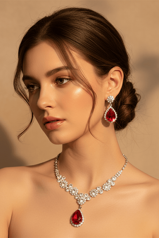 Elegant Heart & Water Drop Pendant Necklace Set by CJ | 0 from Luxe Lane | SKU: CJLX254655301AZ | Barcode:  | Options: Green | Woman wearing a red teardrop necklace and earrings against a beige background