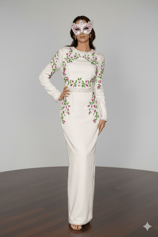 Floral Embroidered Long Sleeve Bodycon Maxi Evening Dress by Luxe Lane | Party dresses from Luxe Lane | SKU: W11638-1 | Barcode:  | Options: White S(2) | Woman wearing a white dress with floral patterns and a matching mask on a plain background