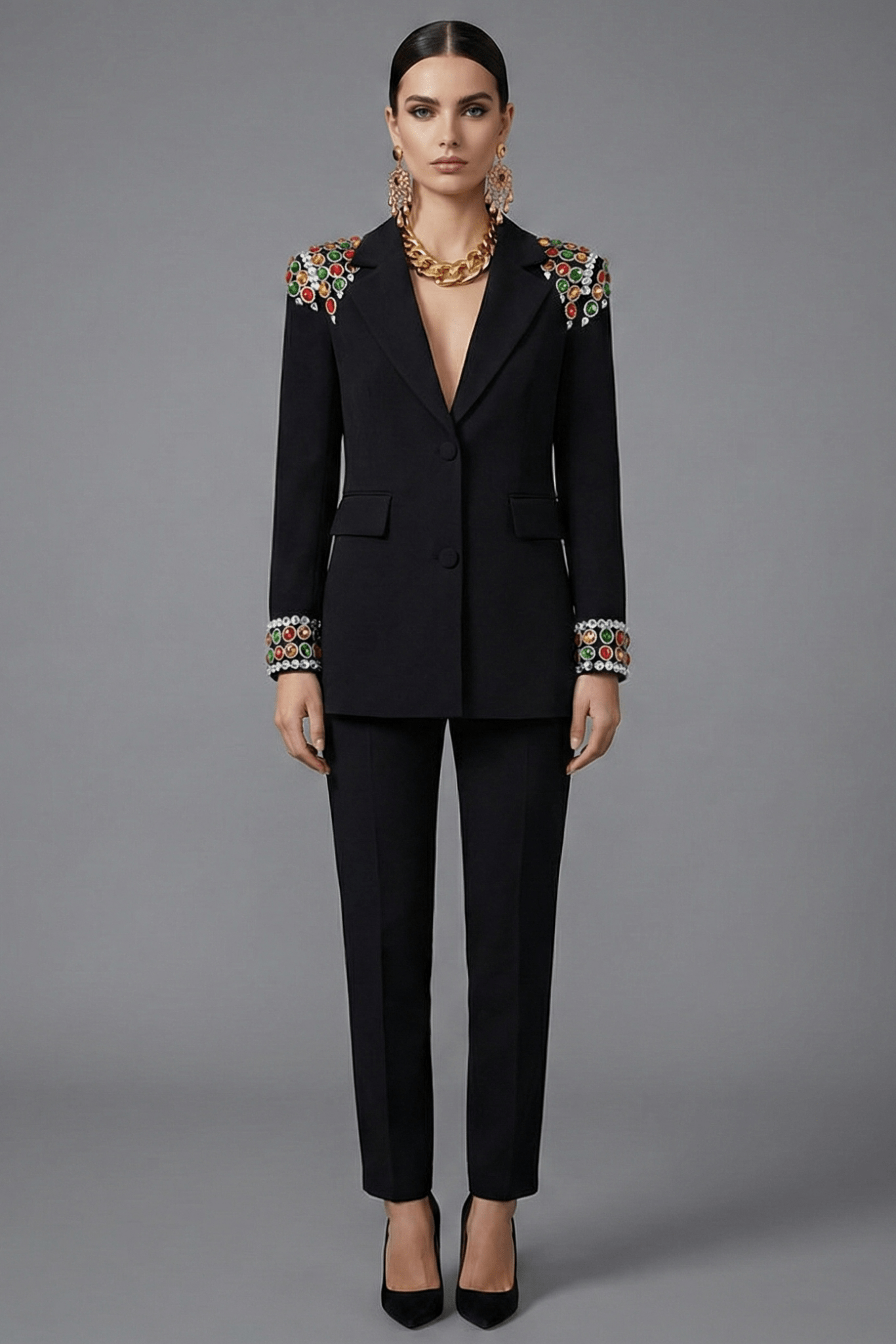 Gemstone Shoulder Tailored Long Blazer Jacket by Luxe Lane | Outerwear from Luxe Lane | SKU: -1 | Barcode:  | Options: Black S(2) | Woman wearing a black suit with floral embellishments on a gray background