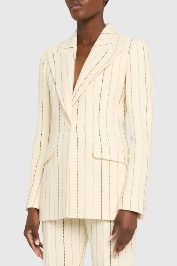Ivory Pinstripe Tailored Blazer & Flared Pants Suit by Shine | Blazer from Luxe Lane | SKU:  | Barcode:  | Options: S(2) | Person wearing a cream pinstripe suit on a plain background