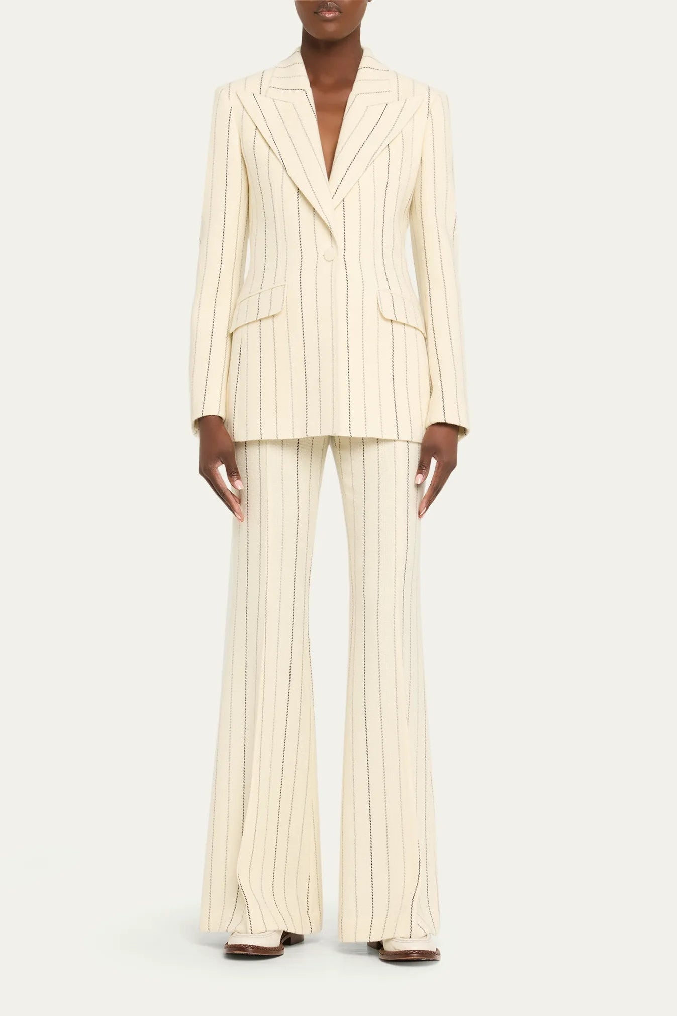Ivory Pinstripe Tailored Blazer & Flared Pants Suit by Shine | Blazer from Luxe Lane | SKU:  | Barcode:  | Options: S(2) | Person wearing a cream pinstripe suit on a white background